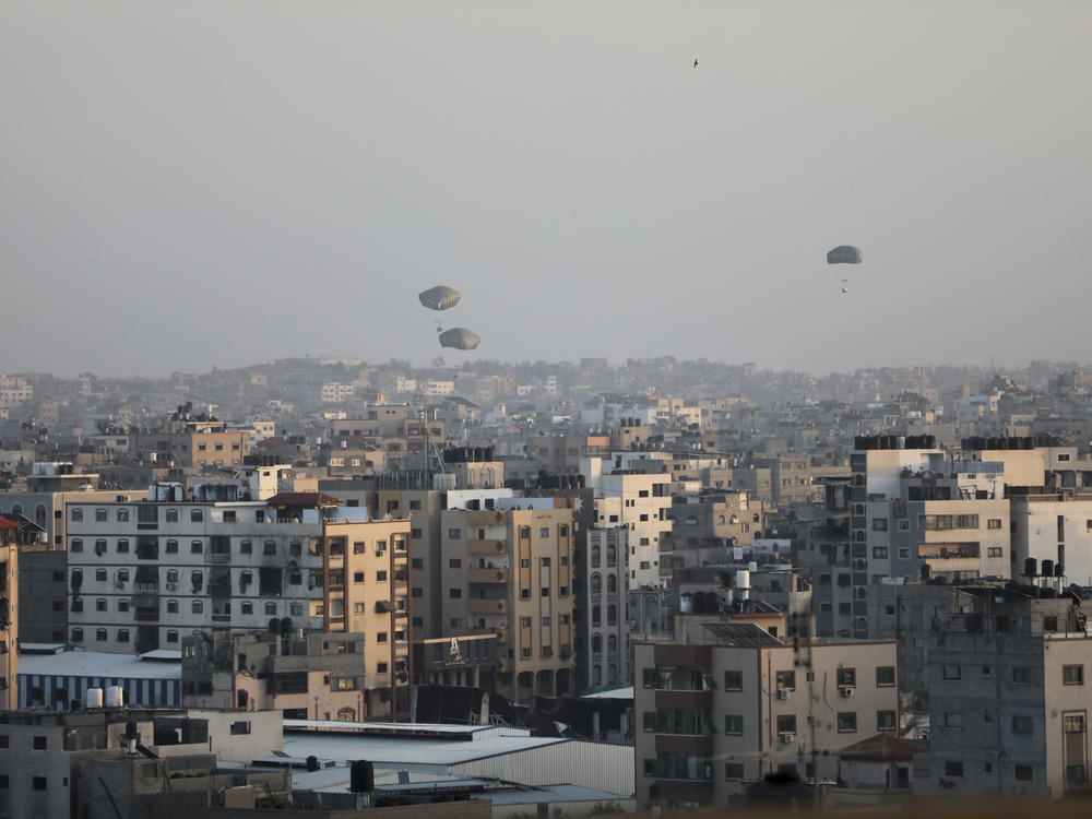 Humanitarian aid is dropped, through a joint effort by the United States and Jordan, over Gaza City on Saturday, March 2.