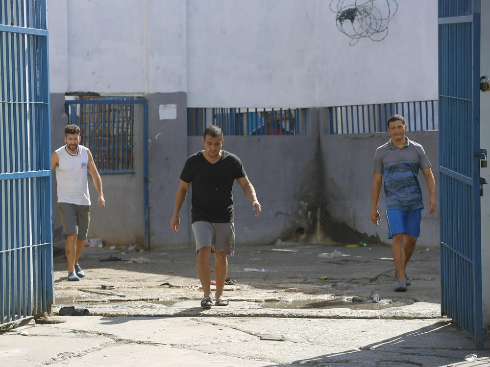 Colombian inmates accused of participating in the assassination of Haitian President Jovenel Moise walk inside the National Penitentiary in Port-au-Prince, Haiti, Sunday, March 3, 2024.