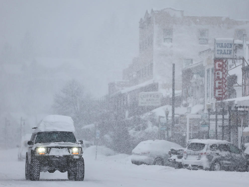 Snow falls downtown, north of Lake Tahoe, during a powerful multiple day winter storm in the Sierra Nevada mountains on Saturday in Truckee, California.