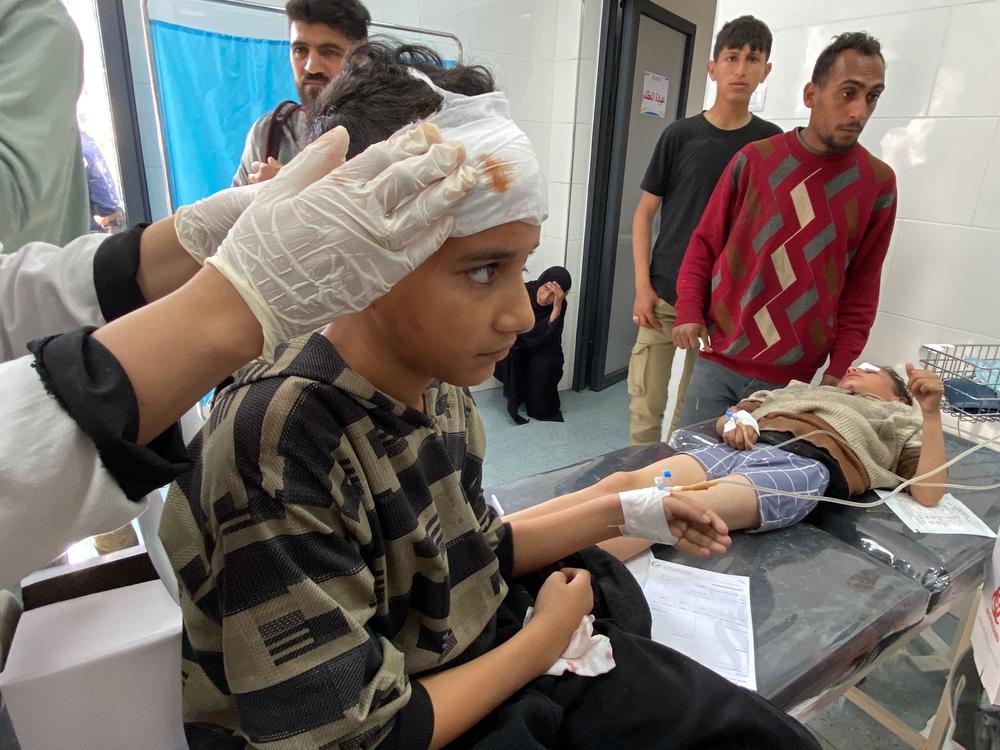 Children are tended to after a strike outside the Emirati Maternity Hospital, in Rafah, on March 2, 2024.