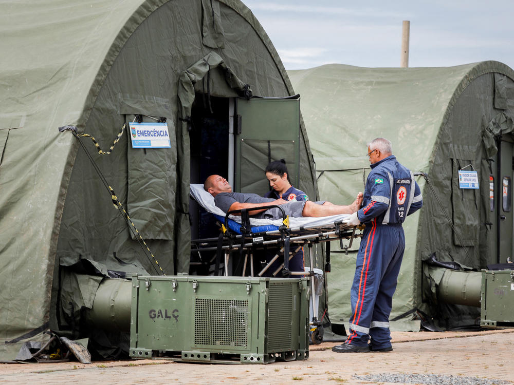A patient is transferred to a hospital after receiving medical care at an improvised military aid station set up to treat suspected cases of dengue fever in the administrative region of Ceilandia, on the outskirts of Brasilia, on Feb. 6.