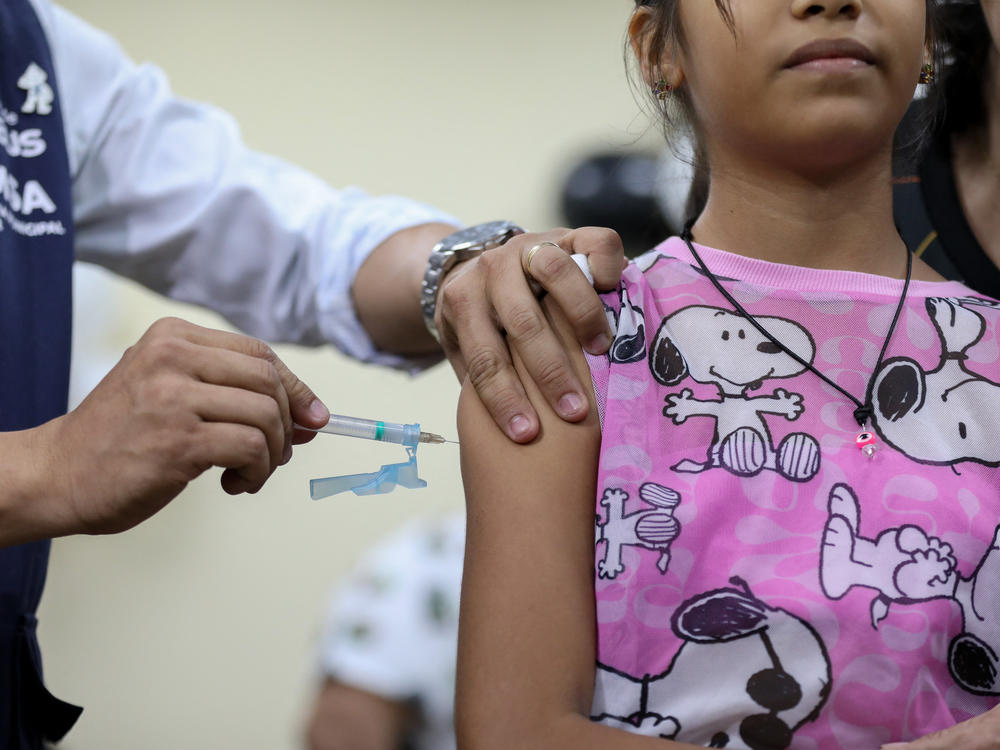 A girl in Manaus, Brazil, receives a dose of the Odenga dengue vaccine on Feb. 22. A previous dengue vaccine, used in the Philippines, was linked to 10 deaths. This new vaccine, according to specialists, has a different formulation; its deployment is being closely monitored.