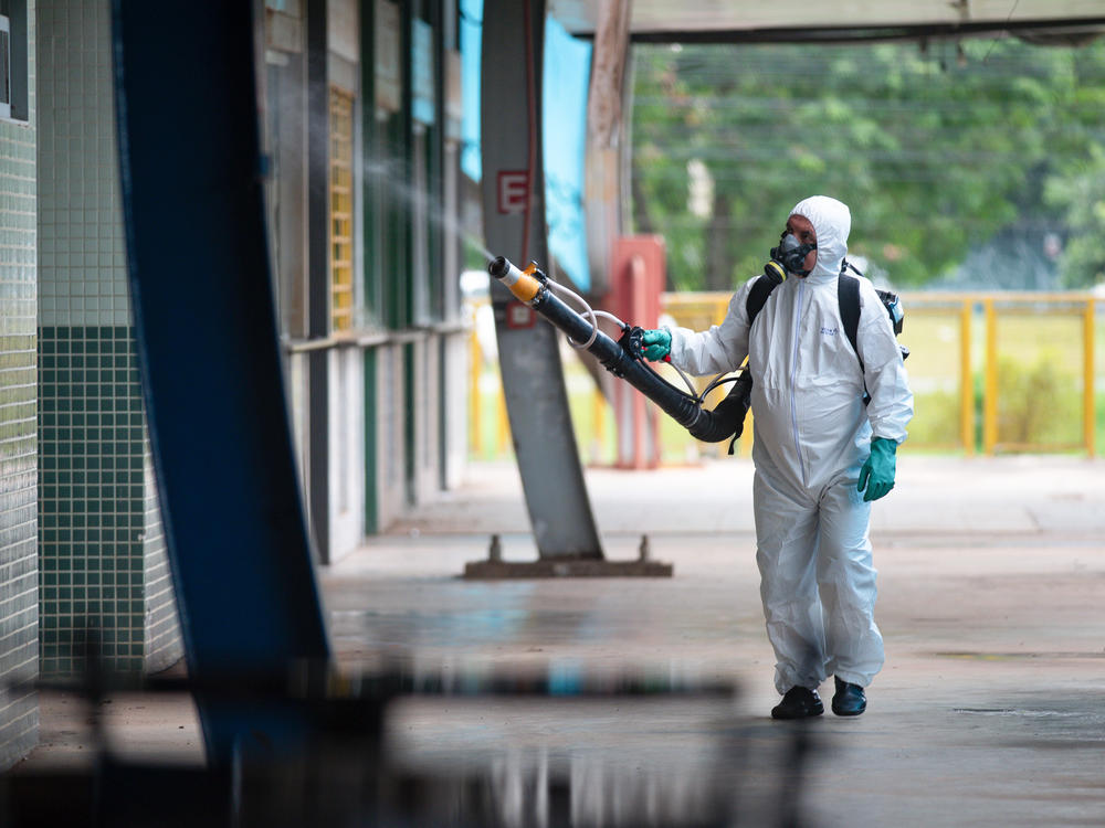 A worker sprays insecticide during a fumigation campaign against the Aedes aegypti mosquito, which spreads dengue, in Brasilia. It's one of many strategies being employed to fight an unprecedented outbreak of the virus.