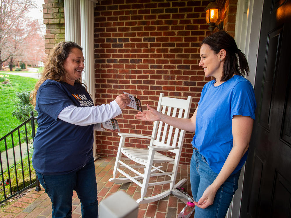 Nicole Sidman talks with prospective voter Rebekah Rubenstein on Sunday in Charlotte, N.C., ahead of Super Tuesday.