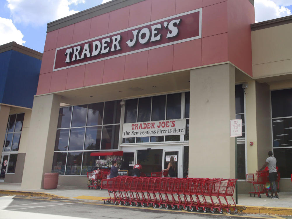 People stand in line waiting to enter Trader Joe's to buy groceries in Pembroke Pines, Fla., on March 24, 2020. More than 61,000 pounds of steamed chicken soup dumplings sold at Trader Joe's are being recalled for possibly containing hard plastic, U.S. regulators announced Saturday, March 2, 2024.