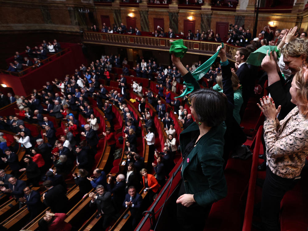 French lawmakers applaud after National Assembly President Yael Braun-Pivet announced the result of the vote during a joint session of parliament in the Palace of Versailles, southwestern of Paris, on Monday, to anchor the right to abortion in the country's constitution.