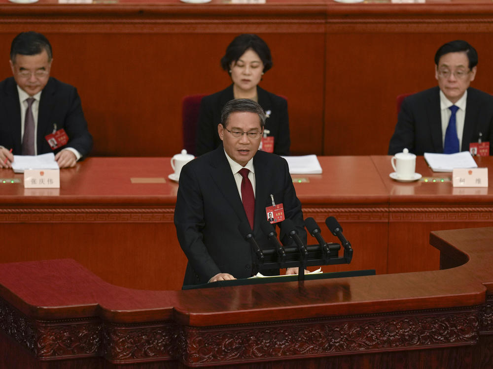 Chinese Premier Li Qiang, center, speaks during the opening session of the National People's Congress (NPC) at the Great Hall of the People in Beijing, China, Tuesday, March 5, 2024.