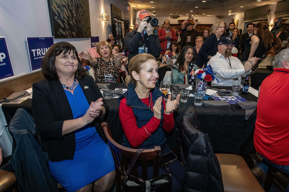 Supporters of former President Donald Trump cheer as he is declared the projected winner in Massachusetts during a 
