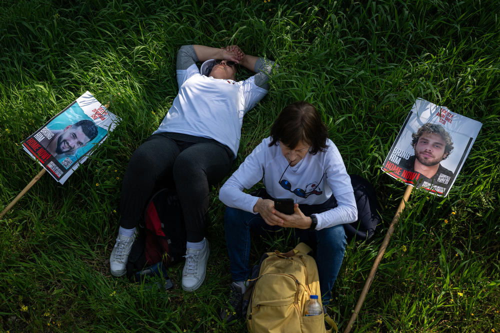 People rest during a break outside of Kibbutz Alumim, Israel, which was attacked on Oct. 7, as families of the hostages held in Gaza and supporters march from southern Israel to Jerusalem on Feb. 28.