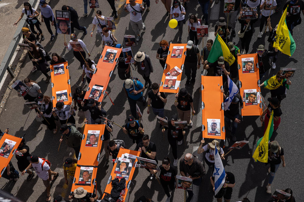 Families of the hostages being held in Gaza and supporters carry stretchers representing each of the 134 hostages, 100 of whom Israel says are still alive, near Beit Shemesh, Israel, as they make their way to Jerusalem on March 1.