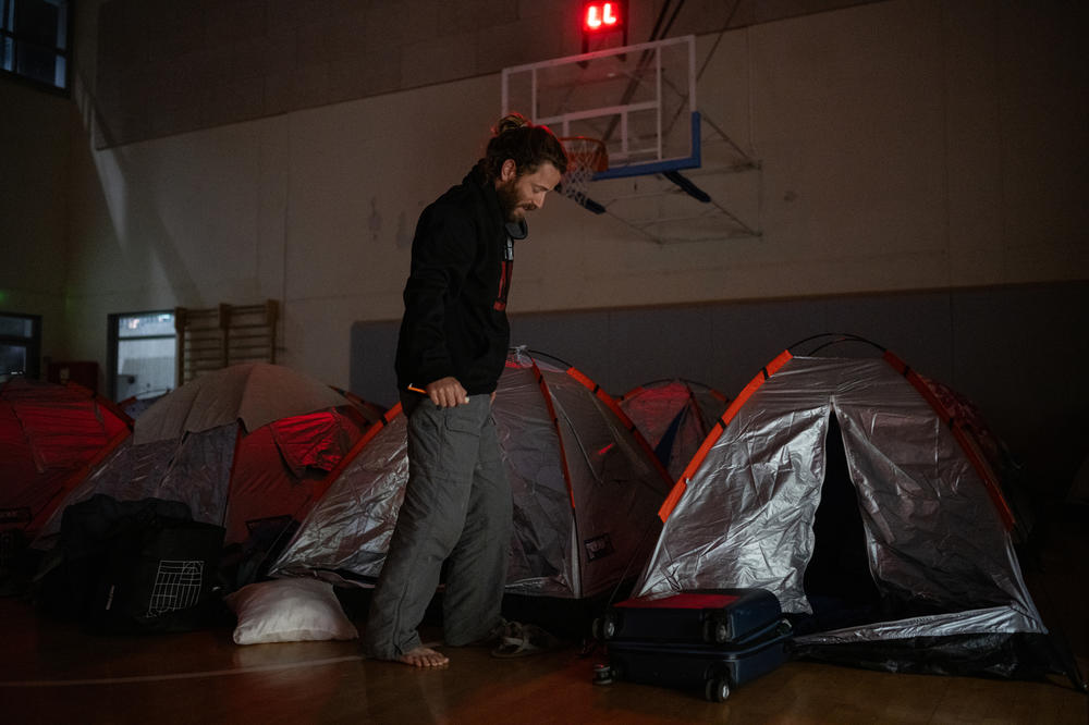 Itay Siegel, whose aunt Aviva was freed and uncle Keith remains hostage, prepares to sleep in a gym at Kibbutz Tsor'a with other families on March 1. 