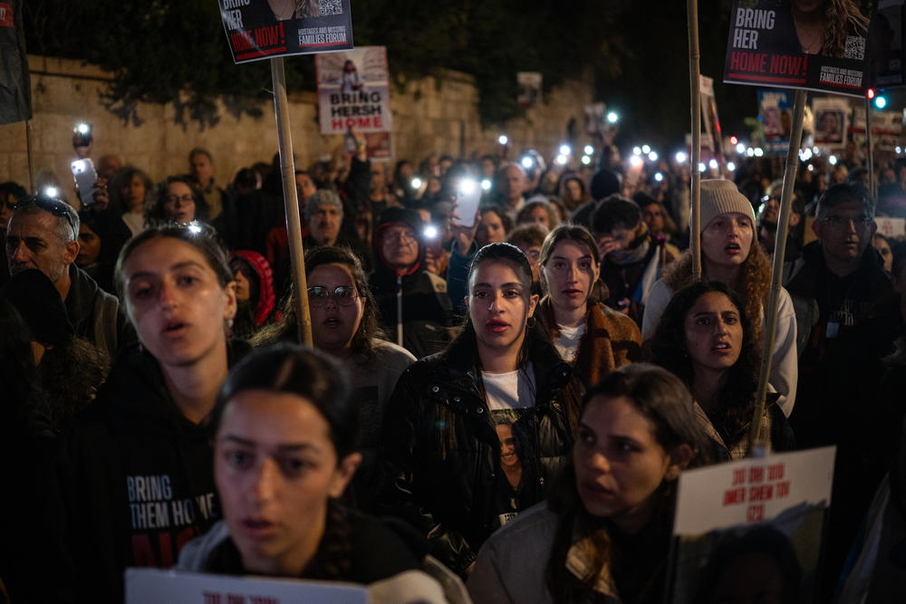 Family members of the hostages still held in Gaza and their supporters sing Israel's national anthem, Hatikvah, at the end of a rally that concluded their four-day march to Jerusalem on March 2.<strong> </strong>Darya Gonen(second row, right), was among them, wearing a black T-shirt with her sister's photo on it.