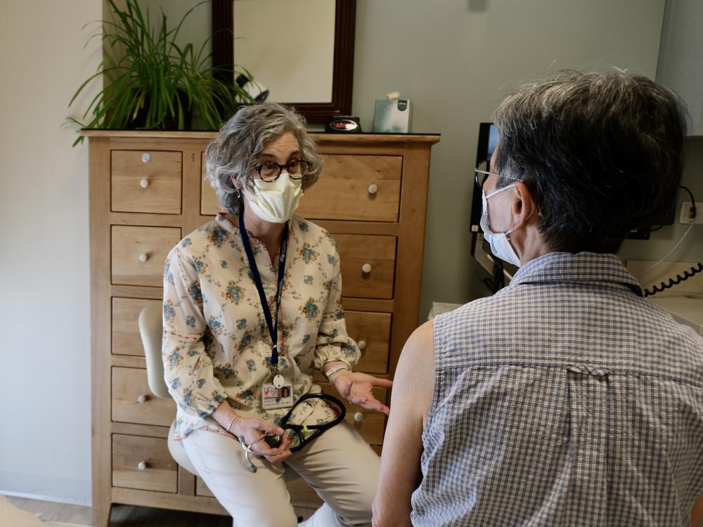 Dr. Louise Aronson, a geriatrician and author, speaks with a patient at UCSF's Osher Center for Integrative Health in San Francisco.