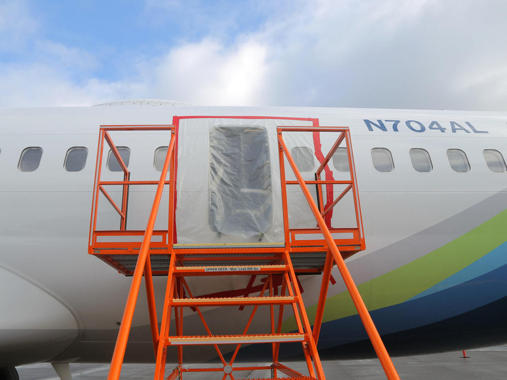In this National Transportation Safety Board handout, plastic covers the exterior of the fuselage plug area of Alaska Airlines Flight 1282 on January 7, 2024 in Portland, Ore. A door-sized section near the rear of the 737 Max 9 blew off 10 minutes after it took off from Portland on January 5.
