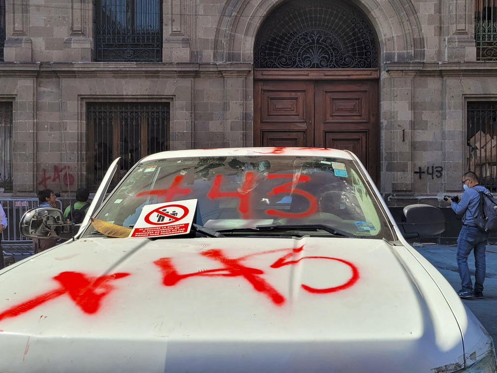 A view of the destruction caused by demonstrators outside the presidential palace in Mexico City on Wednesday, during a protest over the disappearance of the 43 students of the Ayotzinapa teaching training school in 2014. The group of demonstrators knocked down one of the doors of building with a pickup truck.