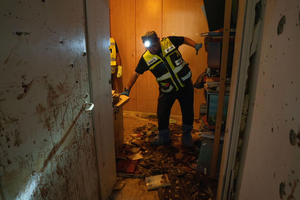 A team of Zaka volunteers clean up human remains from the Oct. 7 attacks in a home in Kfar Azza, Israel.