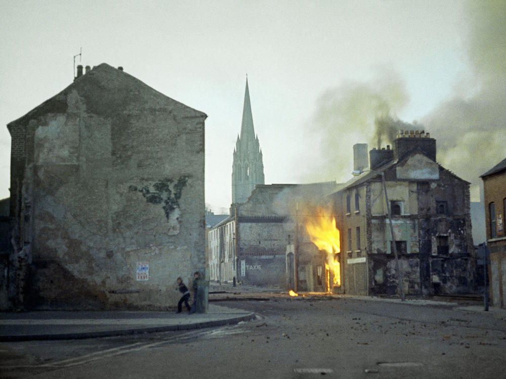 In this February 1972 file photo, a building burns in the bogside district of Londonderry, Northern Ireland, in the aftermath of Bloody Sunday, one of the most notorious events of the period known as the Troubles.