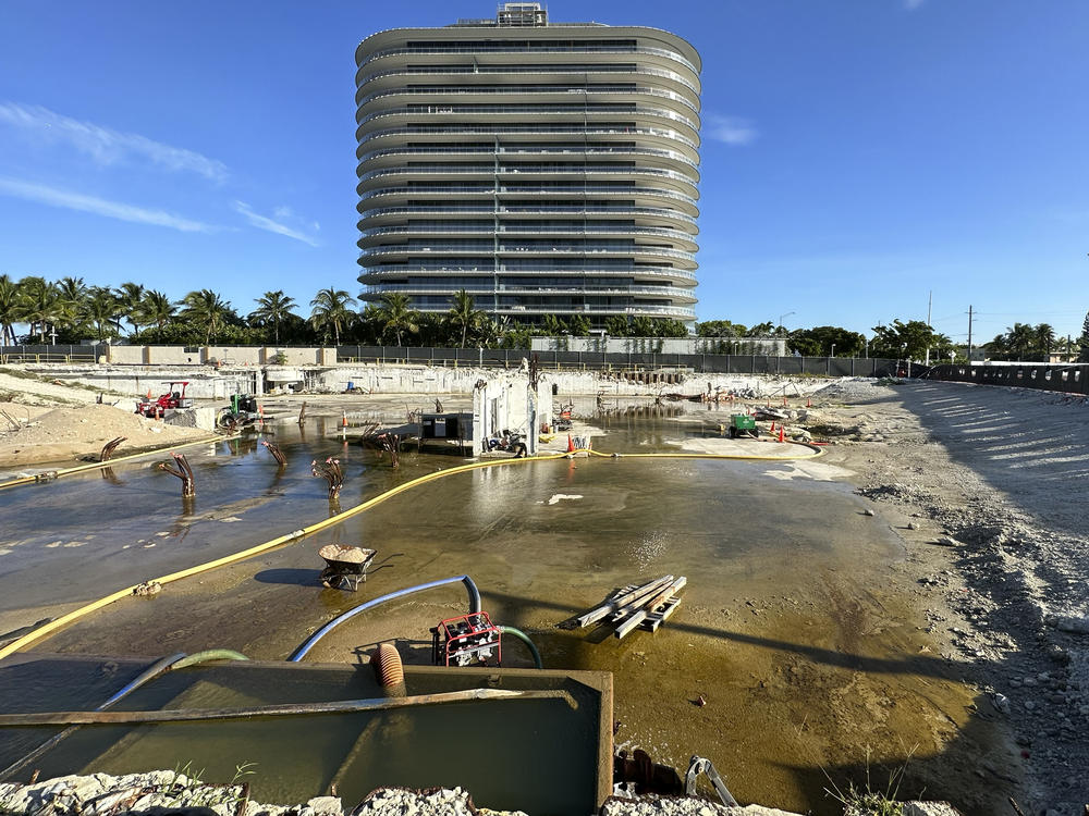 What remains on the site of the Champlain Towers South condo building is shown, June 15, 2023, in Surfside, Fla. The swimming pool deck of a beachfront South Florida condominium that collapsed in 2021, killing 98 people, failed to comply with the original building codes and standards.