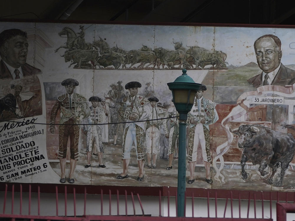 A faded mural of bullfighters decorates the Plaza de Toros México bullring in Mexico City, Dec. 12. Mexico's Supreme Court overturned a 2022 ban on bullfighting in Mexico City, opening the way for events to resume.