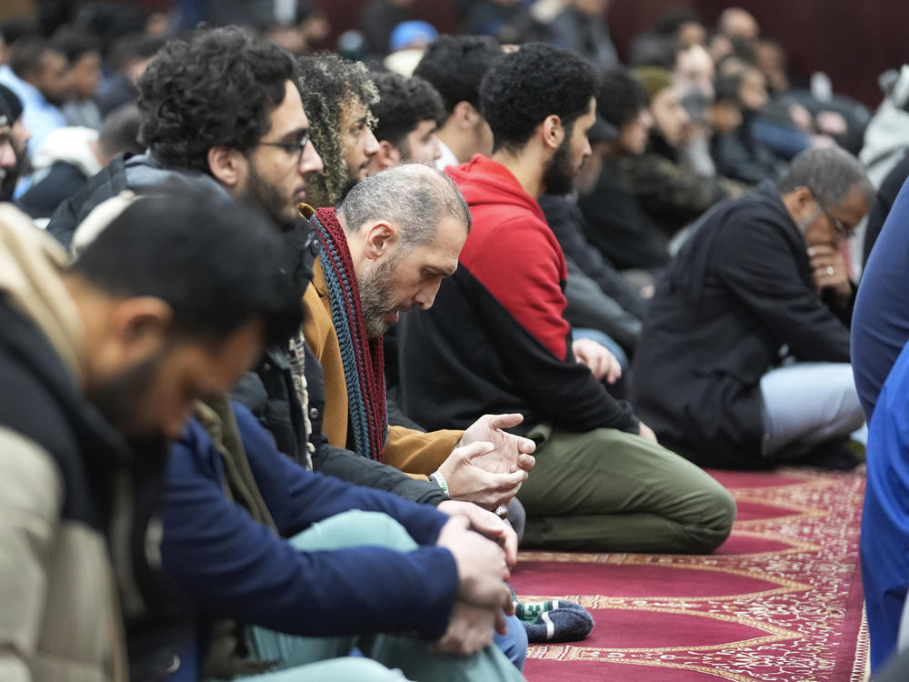 Muslim men listen to Imam Omar Suleiman speak at the Islamic Center of Detroit in Detroit.