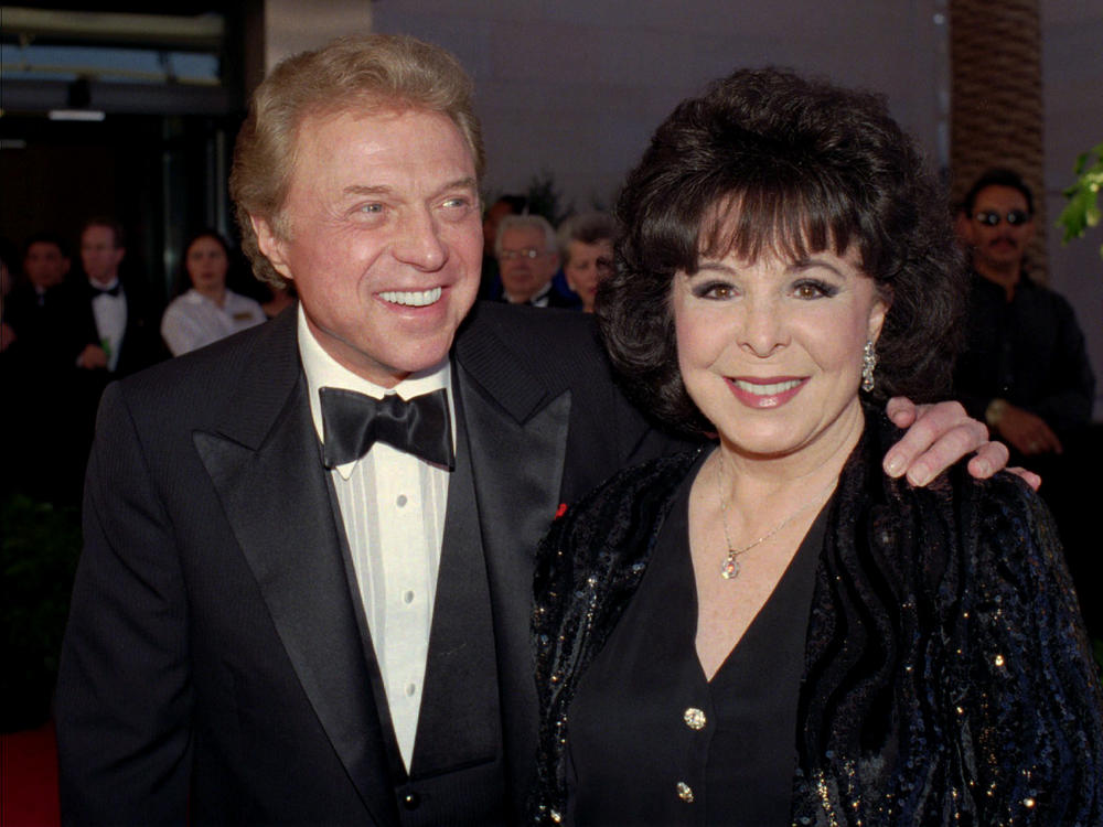 Singer Steve Lawrence (left) and his wife Eydie Gorme arrive at a black-tie gala honoring Frank Sinatra in Las Vegas on May 30, 1998. Lawrence died Wednesday at age 88.