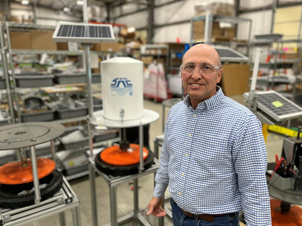On a factory floor in Logan, Utah, farmer Clay Carter demonstrates his company's new irrigation technology that he says helped cut his water use in half.