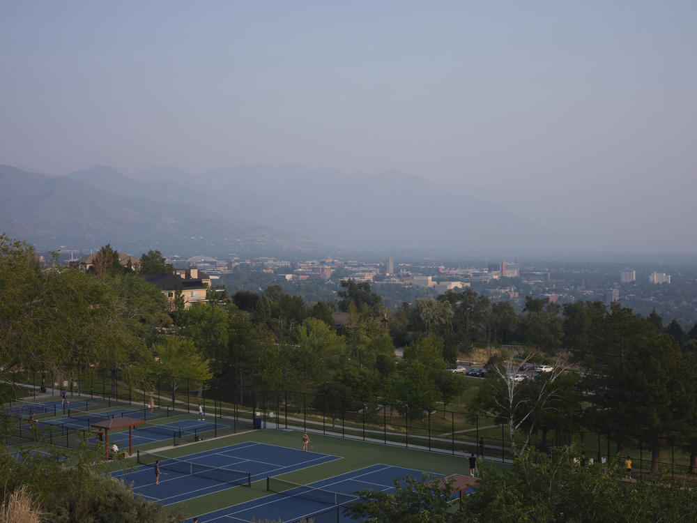 People play tennis amongst the smog in the Salt Lake valley in 2021.