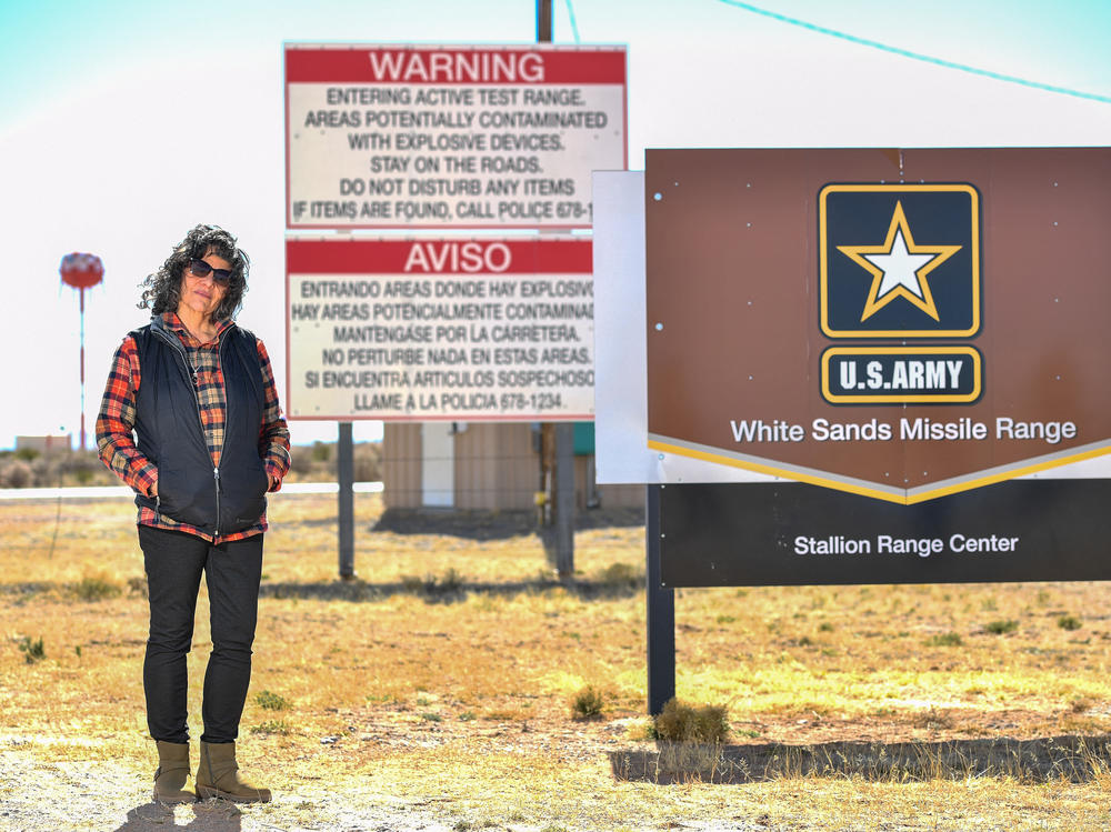 Tina Cordova poses in front of the entrance of White Sands Missile Range where Trinity test site is located. Cordova who is one of five generations in her family diagnosed with cancer since 1945, and runs the Tularosa Basin Downwinders Consortium. Cordova has been fighting for decades to secure compensation for those affected by the radiation from the Trinity test.