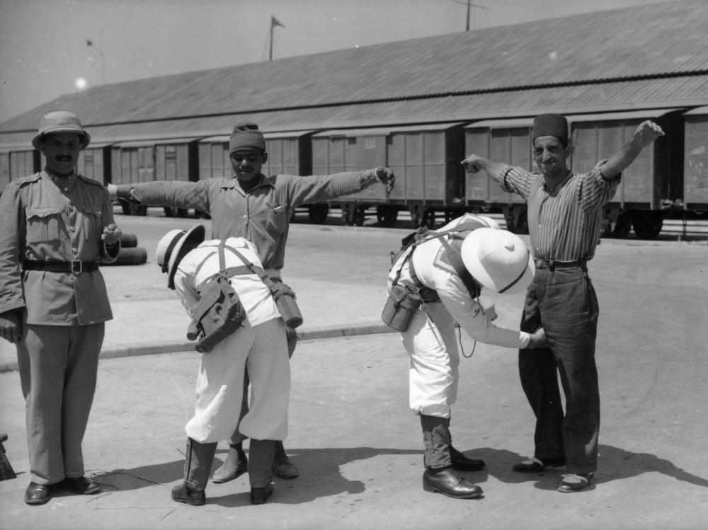 Arab civilians being searched by British military personnel in Mandatory Palestine in 1937.