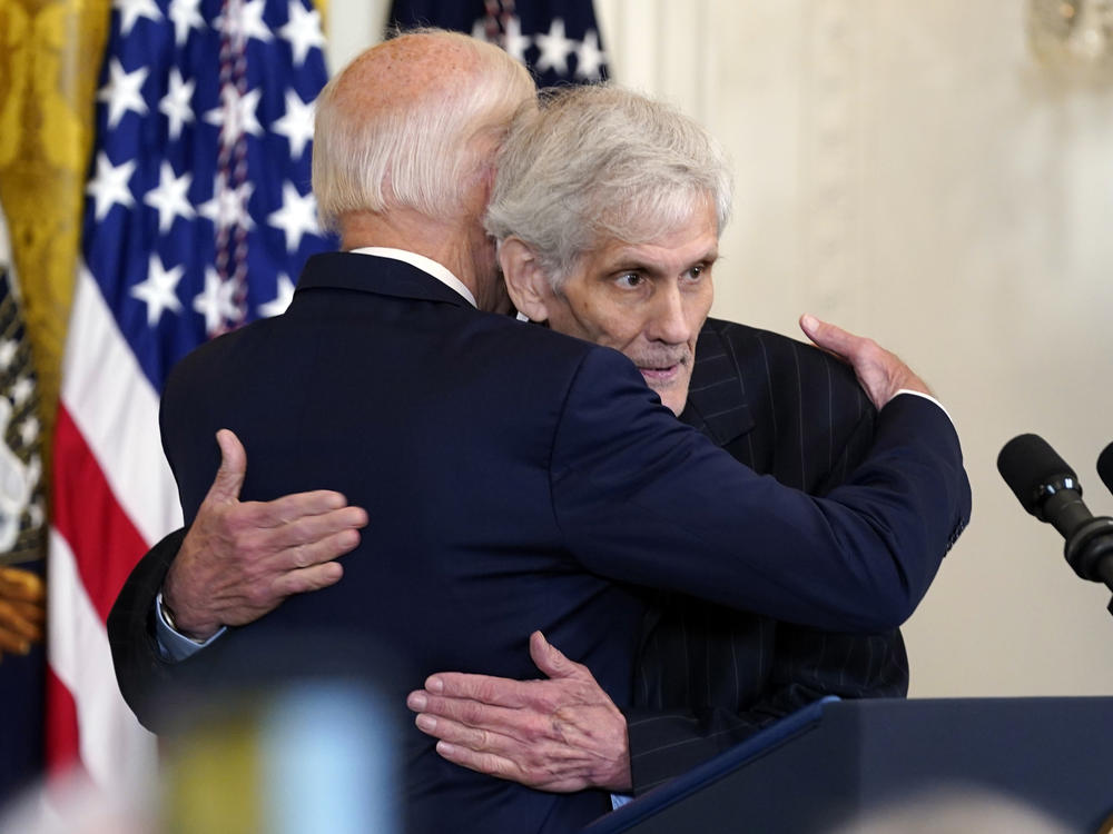 President Biden hugs Steven Hadfield during an event on prescription drug costs at the White House on Aug. 29, 2023. Hadfield, whose prescription costs were dramatically lowered by Biden's signature Inflation Reduction Act, is among the White House guests for Thursday night's State of the Union address.