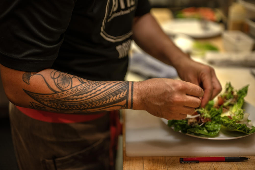 A tattoo of Polynesian bands wraps around Chef Jojo Vasquez's forearm. He says it's a source of inspiration and a reminder of the values that drive him.