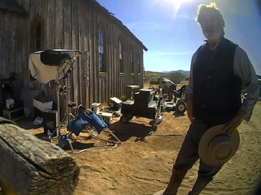 Alec Baldwin, seen here talking to police after a fatal shooting on the <em>Rust</em> movie set in 2021, faces a felony criminal trial in New Mexico this summer. This image is from video released by the Santa Fe County Sheriff's Office.
