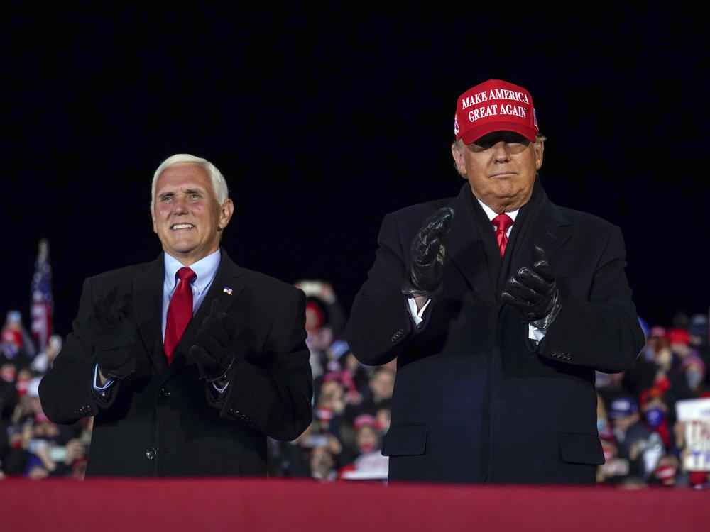 In this file photo, then-President Donald Trump arrives for a campaign rally at Gerald R. Ford International Airport, Nov. 2, 2020, in Grand Rapids, Mich., with then-Vice President Mike Pence.