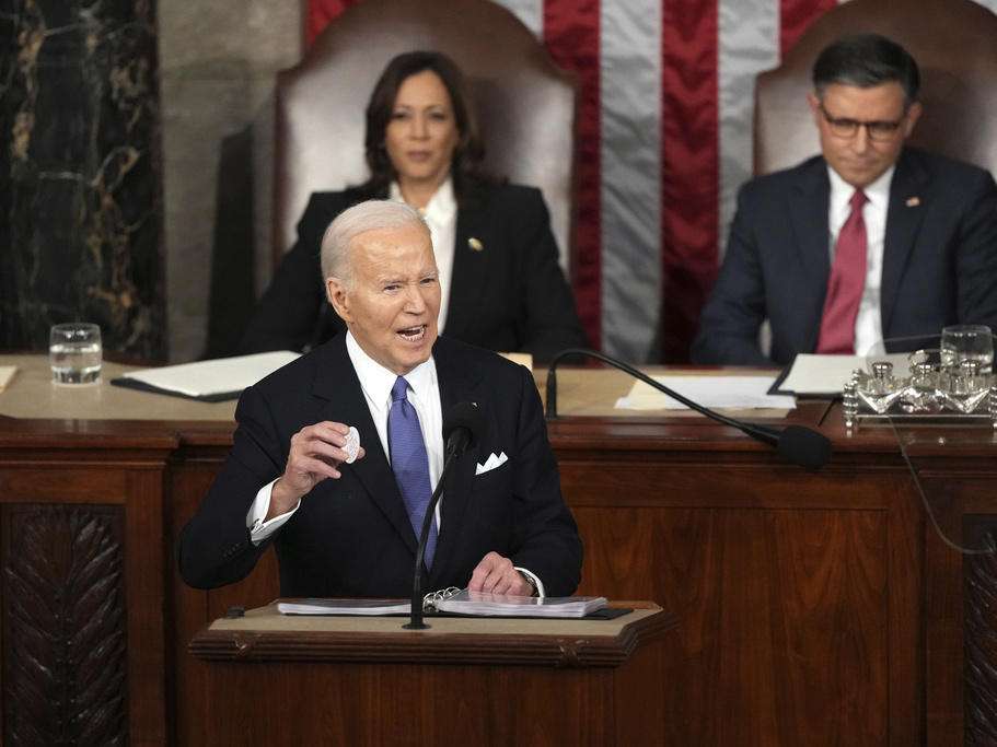 President Joe Biden holds a Laken Riley button as he delivers the State of the Union address to a joint session of Congress at the U.S. Capitol, Thursday March 7, 2024.