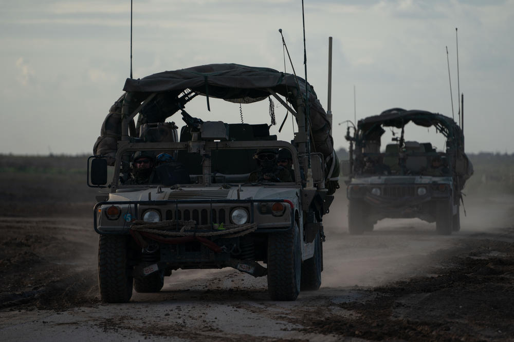 Israeli Jeeps leave Gaza, as seen from Israel's southern border with the Gaza Strip, Thursday.