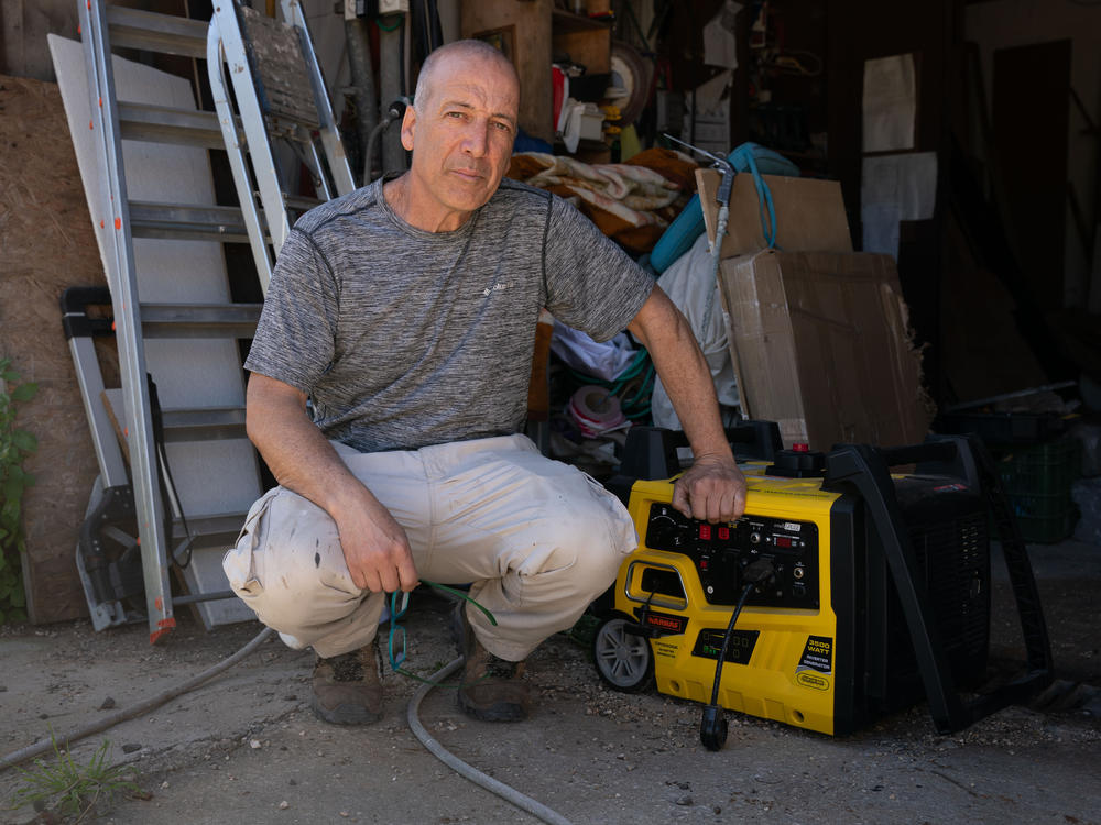 Raviv Kahan, 54, poses in his shed with a generator he bought in preparation for a possible war with the Hezbollah militia in neighboring Lebanon. Kahan volunteers in a civil search and rescue unit, and has outfitted his house in Rishpon, Israel, in case Hezbollah missiles knock out the electricity.