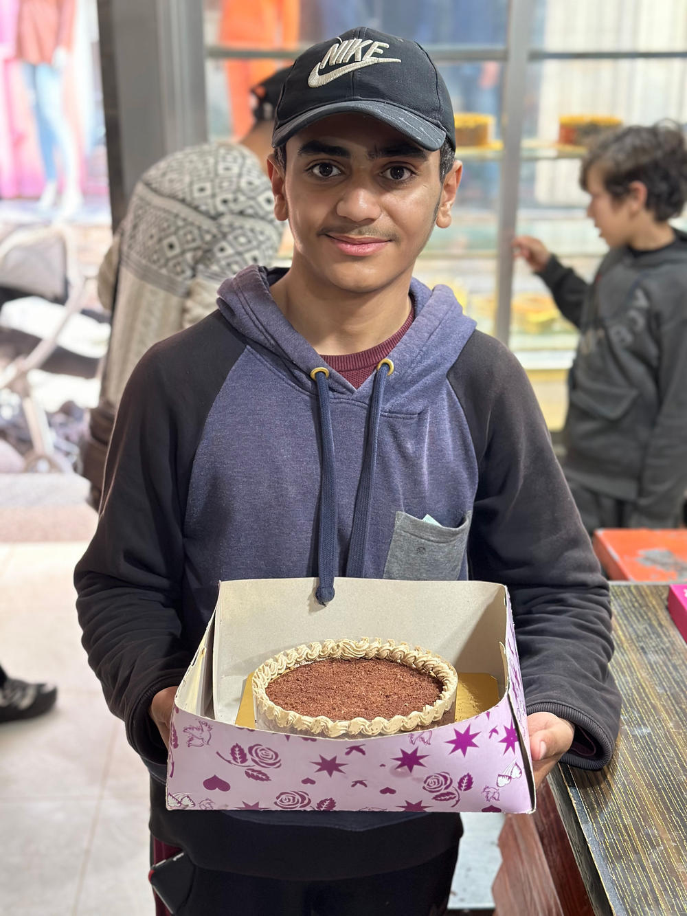 Maher Al Faraa, 18, bought a chocolate cake from Batool Cakes to surprise his aunt for her birthday, in Rafah, Gaza. 