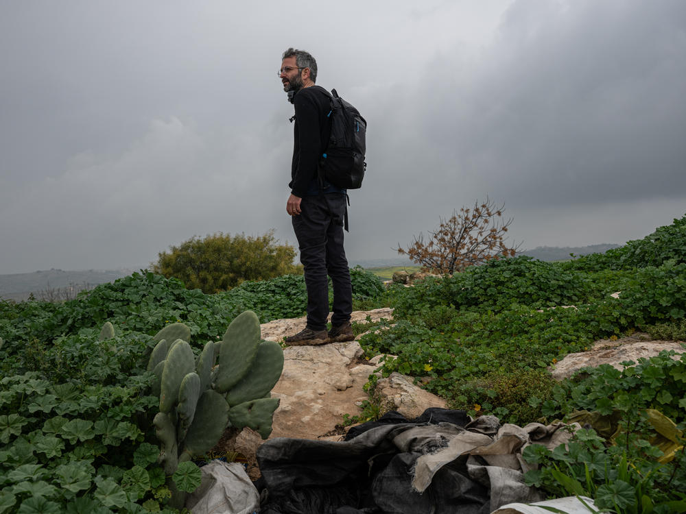 Nadav Weiman, deputy director of Breaking the Silence, walks through the abandoned Palestinian village of Zanuta in the occupied West Bank on Feb. 19.