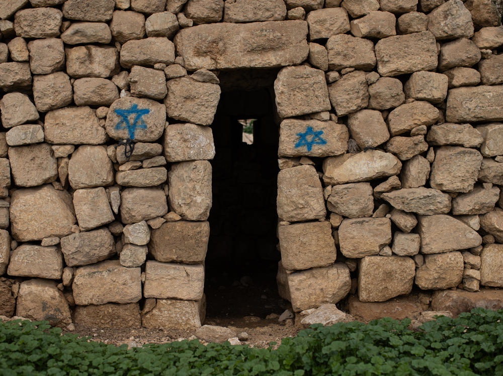 Stars of David are spray-painted on an old structure in the abandoned Palestinian village of Zanuta in the occupied West Bank on Feb. 19.