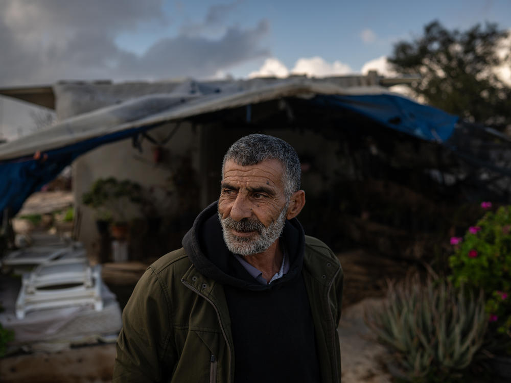 Azzam Nuwaja, a Palestinian farmer, stands for a portrait outside his home in Susya in the occupied West Bank.