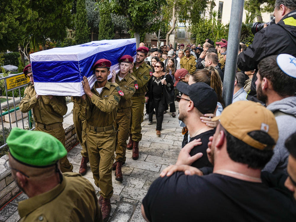 Israeli soldiers carry the casket Israeli Staff Sgt. David Sasson as mourners gather during his funeral in Netanya, Israel, on Thursday, March 7.
