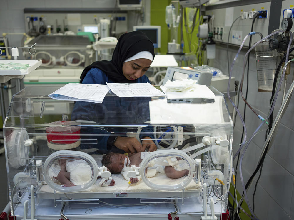 A nurse cares for babies at the premature ward of the Emirati Hospital in Rafah, in southern Gaza, on Friday, March 8. Sixteen premature babies have died of malnutrition-related causes over the past five weeks at the hospital.