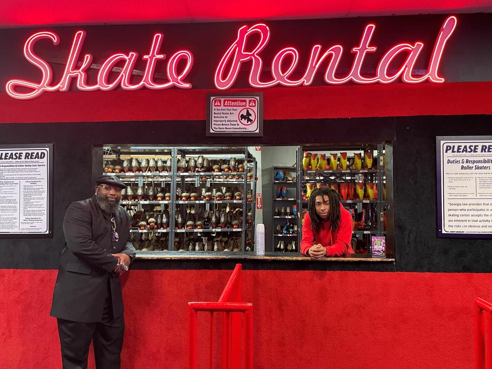 Marcus Allen, left, and an employee at Cascade Skating Rink in Atlanta pose by the Skate Rental counter. Allen last voted in 2008, when he cast a ballot for Barack Obama. Since then, he feels like politicians don't do enough for him to vote for them.