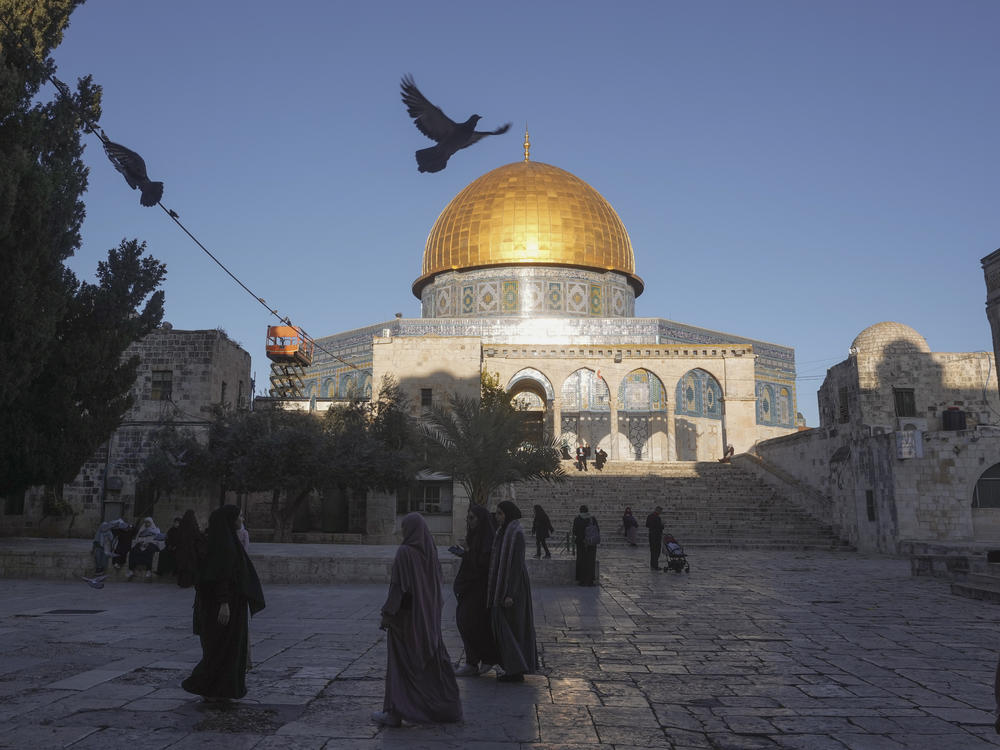 Muslims walk next to the Dome of Rock Mosque at the Al-Aqsa Mosque compound in Jerusalem's Old City, Sunday, March 10, 2024.