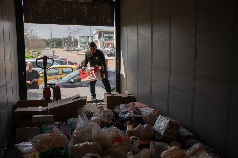 Activists from Standing Together set out in a convoy, including a large truck holding donated dried goods and cans, with the goal of delivering aid directly to Gaza on March 7. The group was blocked en route to Israel's Kerem Shalom border crossing with Gaza by Israeli police and soldiers.
