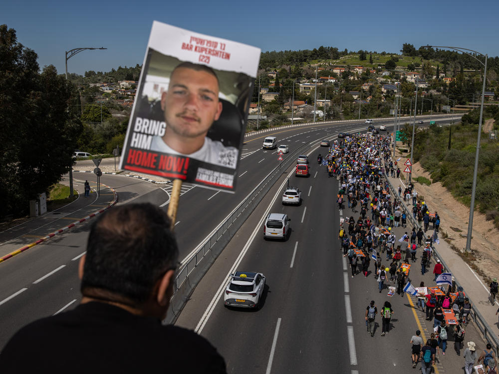Demonstrators near Beit Shemesh, Israel, carry stretchers representing each of the 134 Israelis still being held by Hamas on March 1. Amid fraught negotiations over conditions for a cease-fire, the families of the hostages held a four-day march from areas attacked on Oct. 7 in southern Israel to Jerusalem.