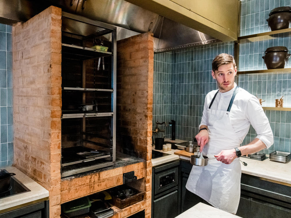 Chef Joseph Lidgerwood prepares to cook beef over a wood fire at Evett restaurant in Seoul, South Korea, Dec. 7.