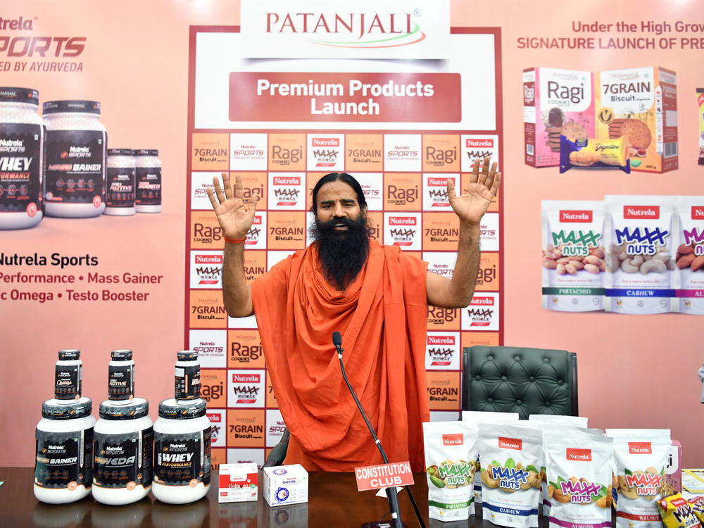 Yoga guru Baba Ramdev, the brand ambassador for the billion dollar company Patanjali Ayurved, addresses the media during a launch of 