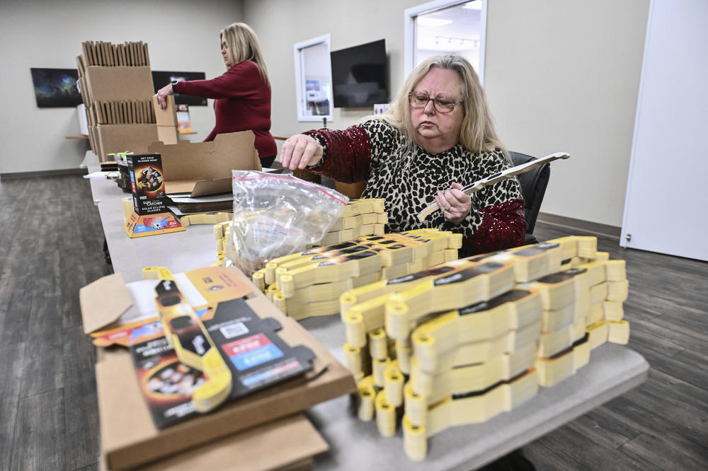 Tammy Hellinga, left, and Joanne Hostetter prepare Sun Catcher solar eclipse glasses for shipment to customers from the Explore Scientific store in Springdale, Ark., on Jan. 30.