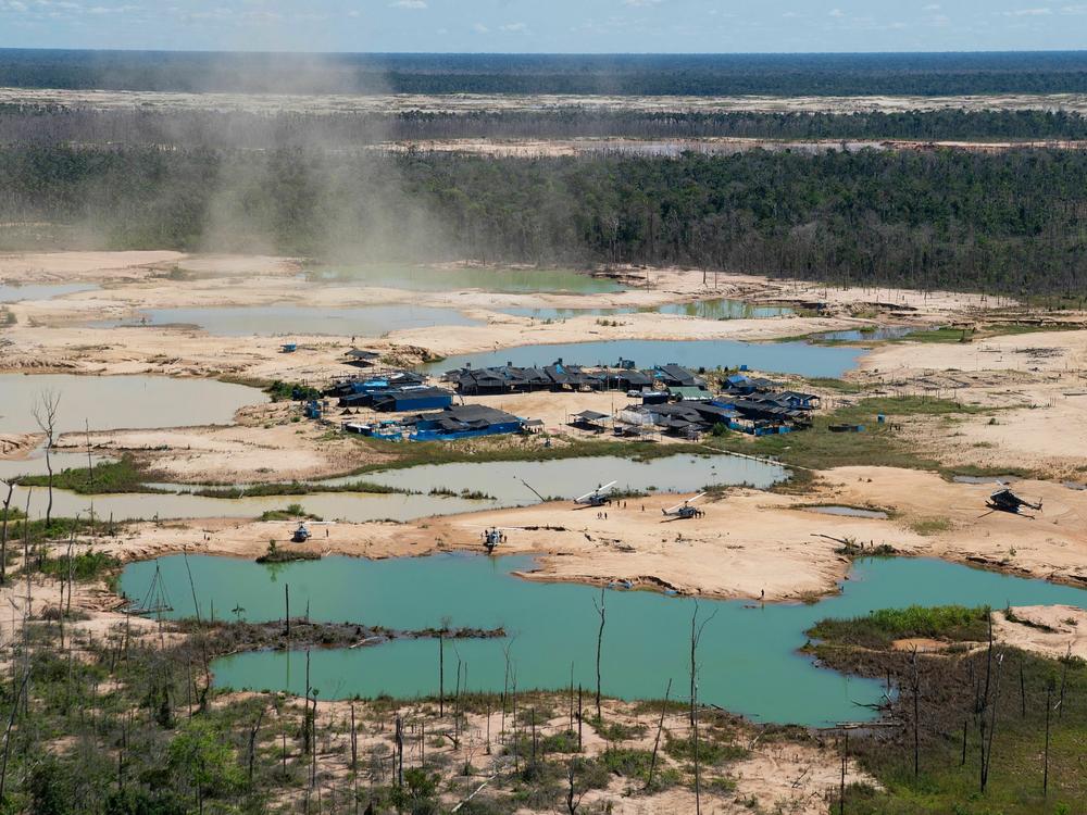 An aerial view of a deforested area of the Amazon jungle caused by illegal mining activities in the river basin of the Madre de Dios region in southeast Peru, from May 2019.